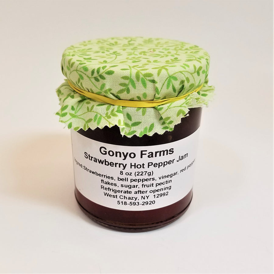 Green ivy patterned cloth banded to a jar of Gonyo Farms Strawberry Hot Pepper Jam