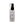 Single glass bottle of Earth Luxe Sweet Dreams Aromatherapy spray standing upright. The top has a black spray dispenser seen through its plastic cover. A pale lilac-colored vertical product label fills the front side of the bottle.