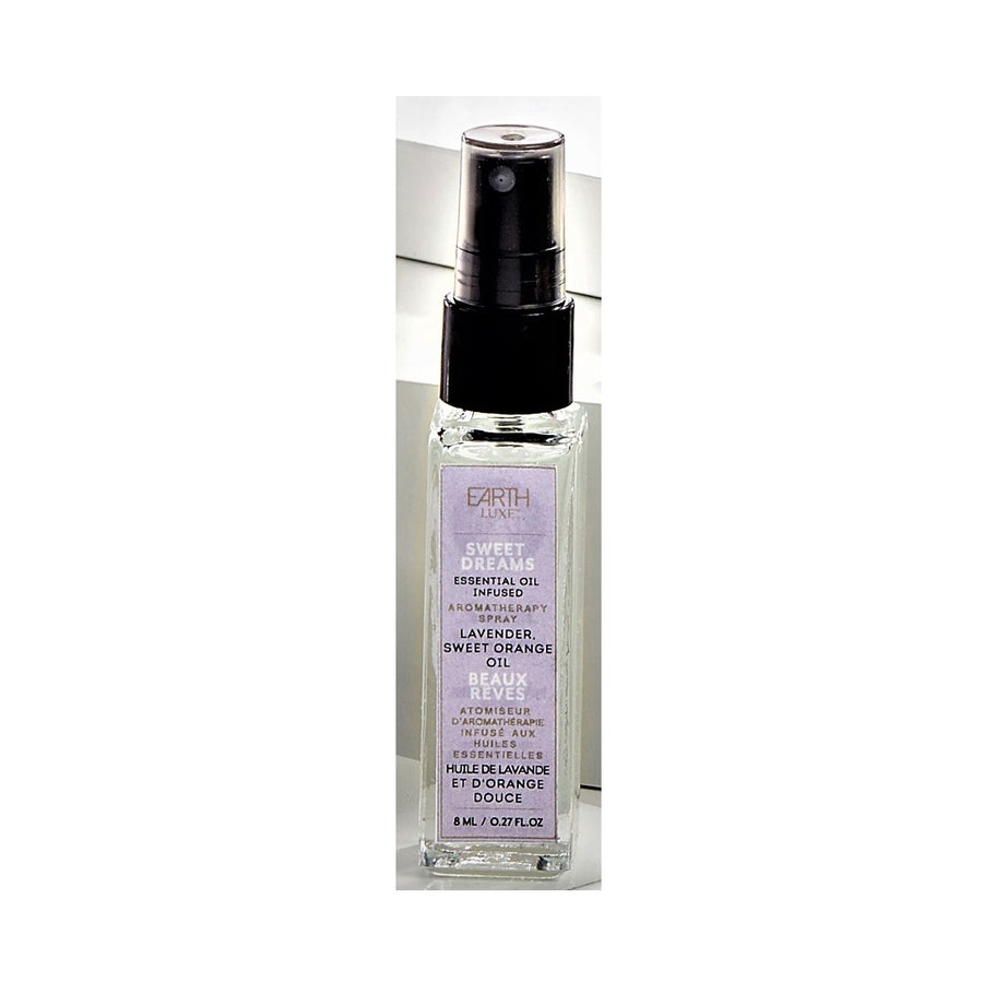 Single glass bottle of Earth Luxe Sweet Dreams Aromatherapy spray standing upright. The top has a black spray dispenser seen through its plastic cover. A pale lilac-colored vertical product label fills the front side of the bottle.