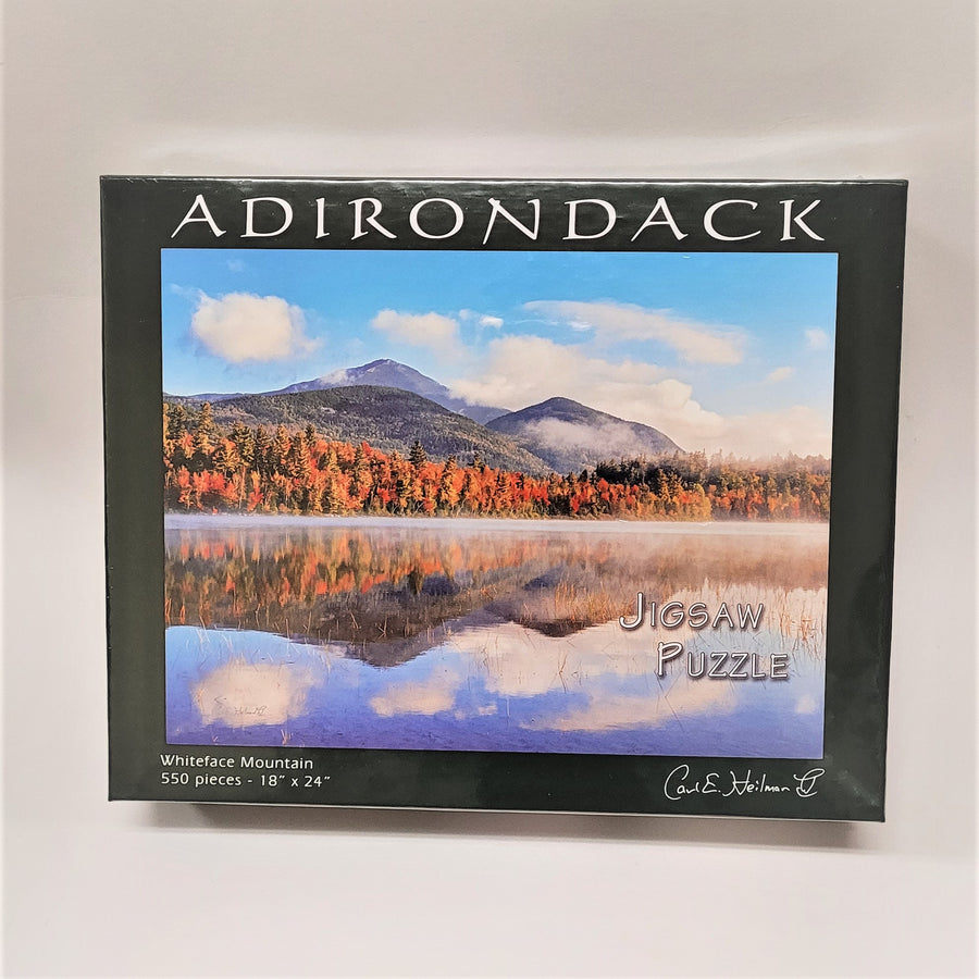 Box cover of the Adirondack puzzle featuring Carl Heilman's photo of Whiteface Mountain reflected in the water below.