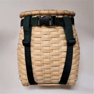 Front of youth pack basket with dark green straps around a natural-colored woven basket.